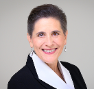 A professional headshot of nonprofit leadership workshop speaker Cindi Creager, smiling warmly and wearing a black blazer over a white collared shirt.