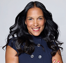 A professional headshot of nonprofit leadership workshop speaker Cristina Jones smiling warmly, with long dark wavy hair, wearing a navy blue top with buttons.