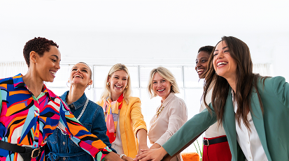 This nonprofit leadership workshop emphasizes team unity, support, and trust. Shown here as a diverse group of women joining hands.